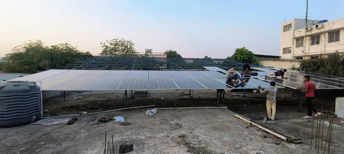 Technicians installing solar modules on a rooftop